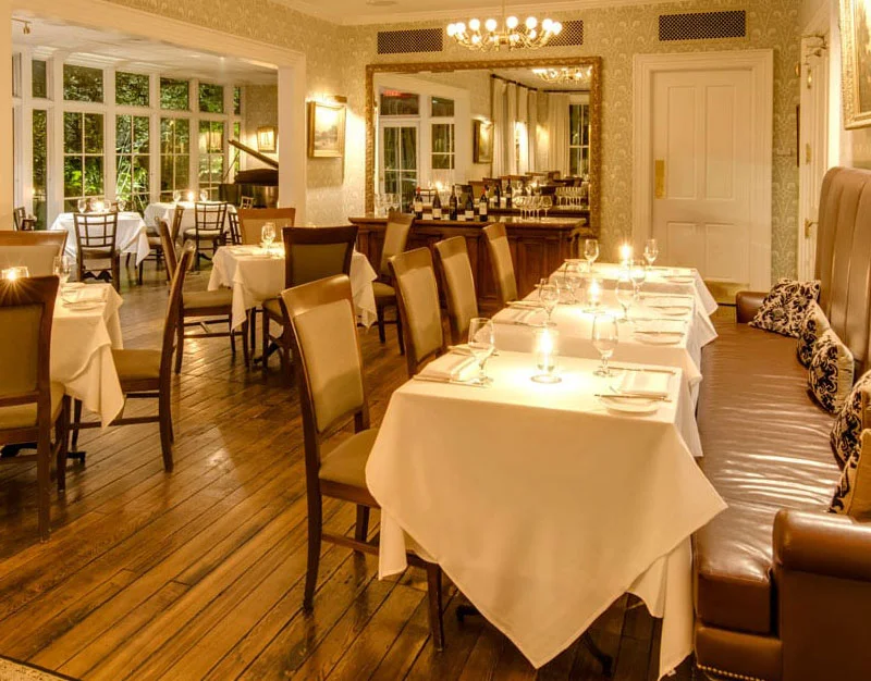 a dining room with tables and chairs and a chandelier