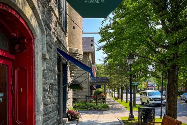 a street sign hanging from the side of a building