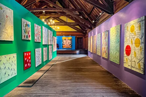 a room with a lot of paintings on the wall