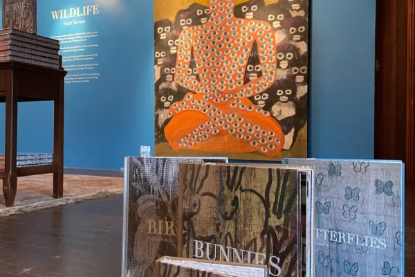 a display case with a buddha statue on top of it